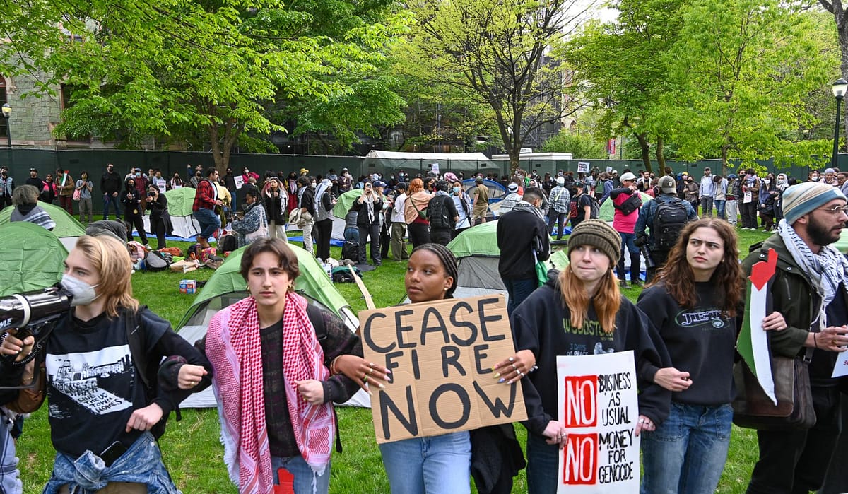 Pro-Palestinian protestors form a human chain around an encampment at the University of Pennsylvania. Photo by Joe Piette from Flickr.