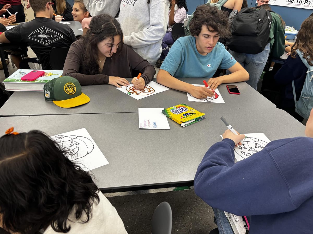 Students draw at a Lunch with Friends meeting.