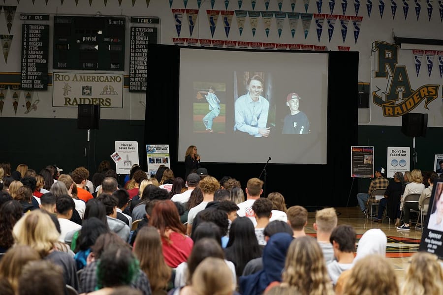 Mother Laura Collanton speaks to students at a fentanyl awareness assembly in 2022.