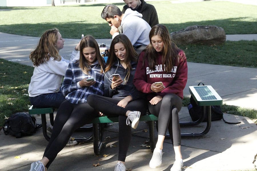 Juniors McKenna Schinderle, Sophia Lynch, and Chloe Franz choose to use their phones instead of reading.